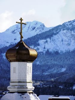 onion dome of St. Nicholas in the winter. a Snow covered Douglas Island is in the background. I