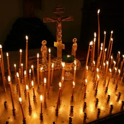 Panikhida tray with three bar cross and lit taper candles. Light a Candle, St. Nicholas Orthodox Church, Juneau